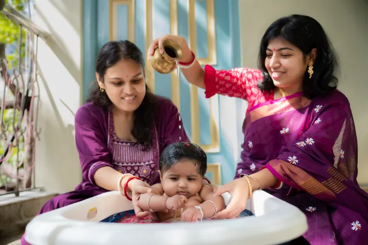 Family performing a traditional ritual for a newborn baby