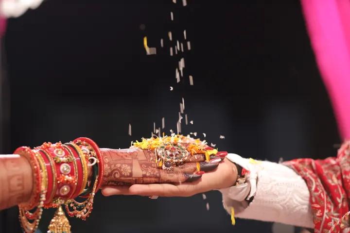 Bride and groom's hands during a traditional Indian wedding ritual
