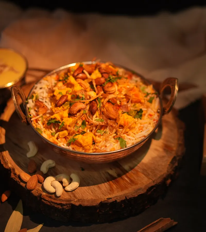 Freshly prepared biryani garnished with cashews and spices